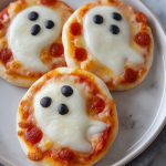 Try out these spooky and delicious Mini Ghost Pizzas for a fun Halloween treat! Easy to make and perfect for a ghostly-themed party.
